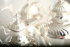A close-up of two beautifully shiny, silver teapots in a bright, white light
